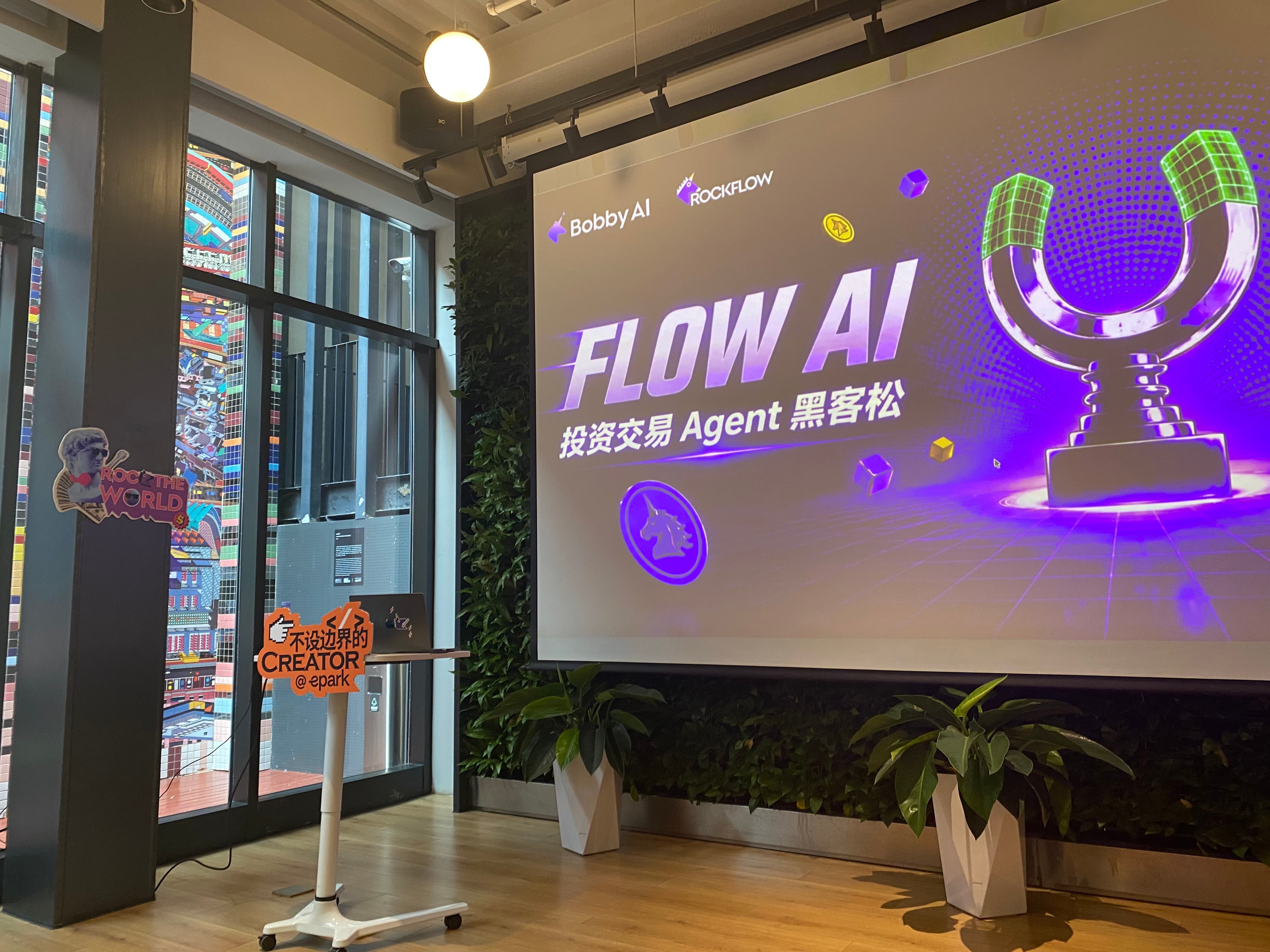 Flow AI investment trading agent hackathon venue screen with Bobby AI and RockFlow branding.